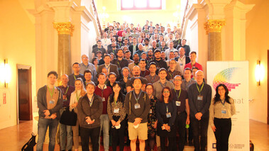 Großes Gruppenbild von Konferenzteilnehmenden im Treppenhaus des Schloss Merseburg.